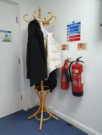 Coats hanging on a rack in an office