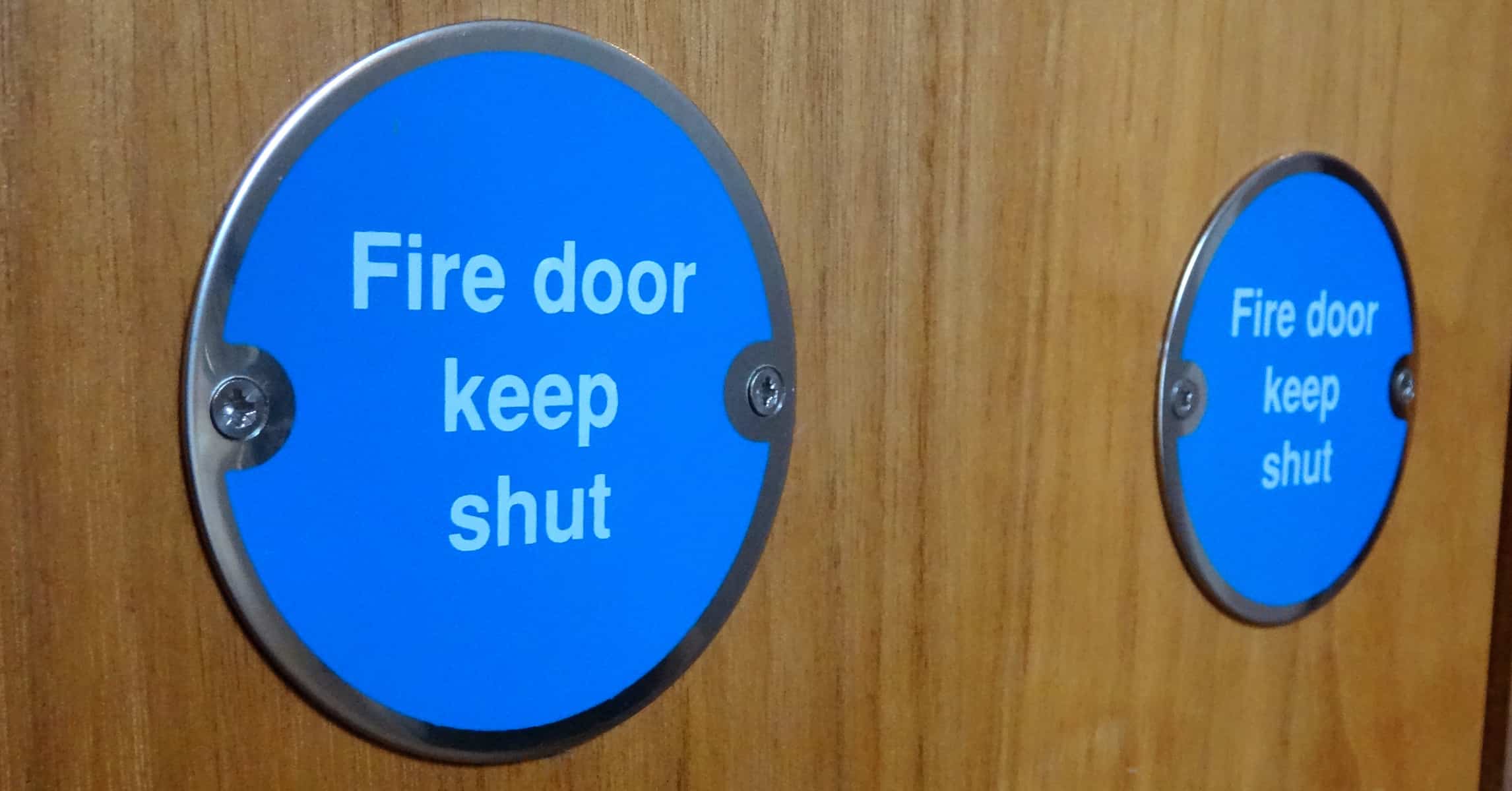 close up of an office door with a sign stating fire door keep shut